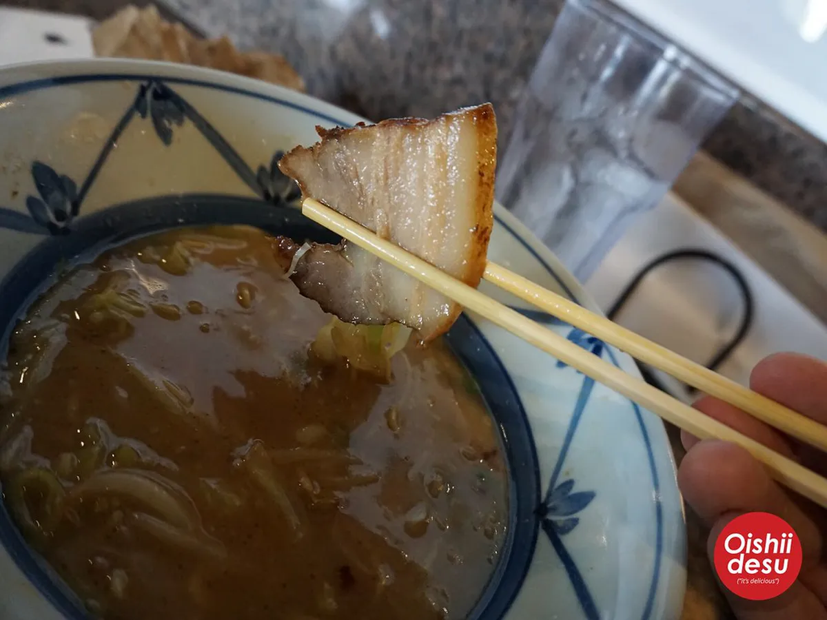 Bowl of Kagoshima ramen with clear pork and chicken broth, noodles, and toppings served in Japan