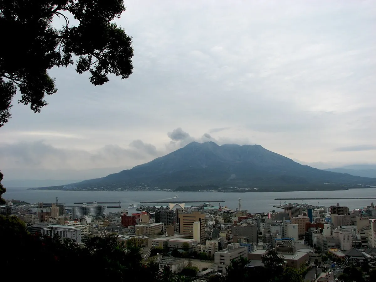 Kagoshima City View Bus passing through downtown streets near tram lines in Japan