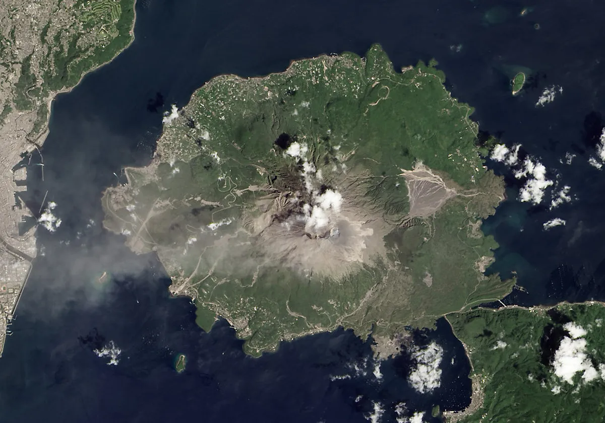 Sakurajima volcano eruption seen from across Kinko Bay with ash plume rising Kagoshima Japan