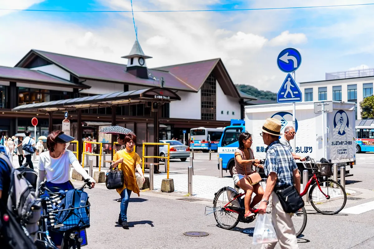 Kamakura Station with its distinctive entrance and busy bus terminal area near the East Exit in Kamakura, Japan