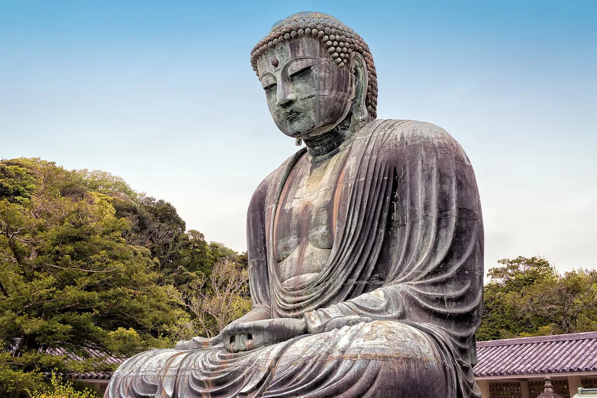 The towering bronze Great Buddha at Kotoku-in Temple in Kamakura, Japan with visitors admiring the iconic 11-meter statue
