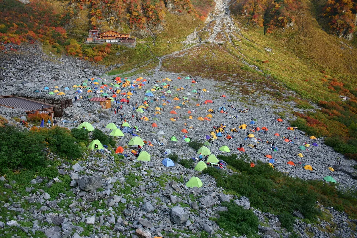 Tents and a mountain hut in the Karasawa Cirque above Kamikochi