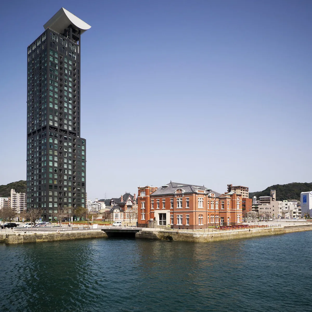 Red-brick Meiji-era buildings and waterfront promenade of Mojiko Retro district with the Kanmon Bridge in Kitakyushu, Japan
