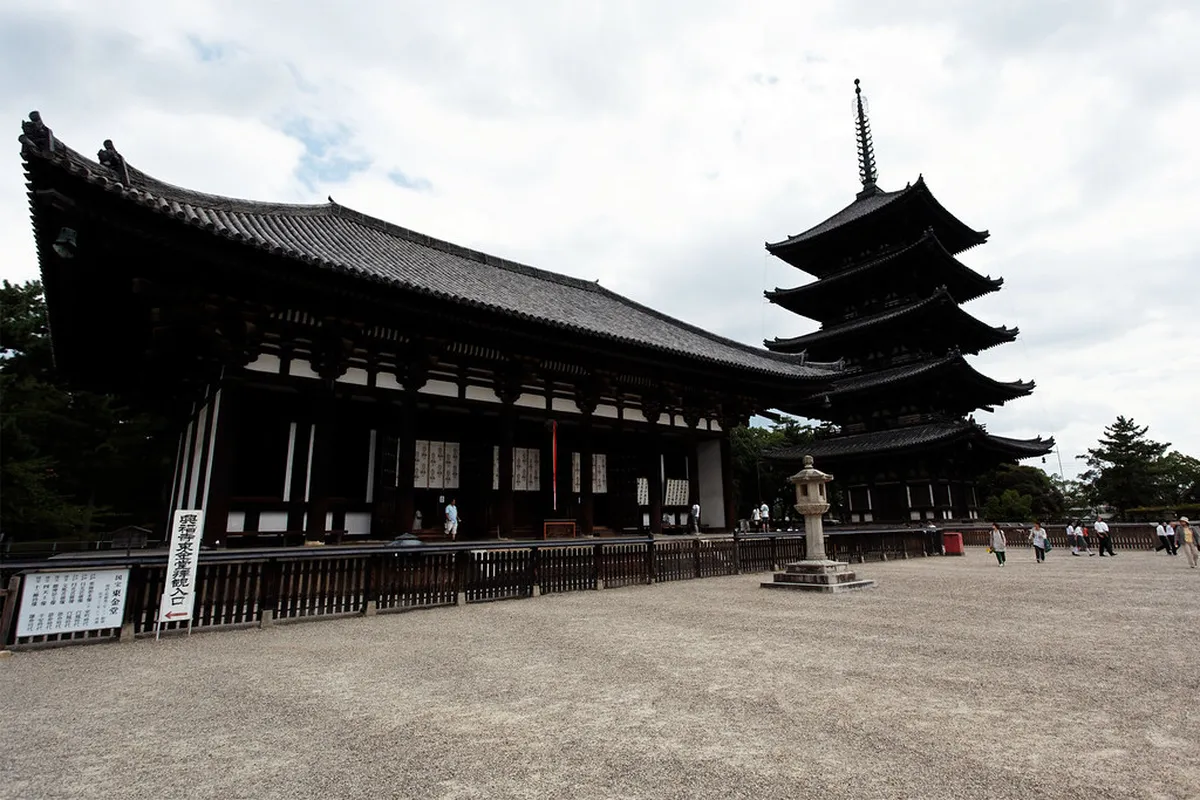 Sarusawa Pond reflecting Kofuku-ji temple buildings on a calm day in Nara, Japan