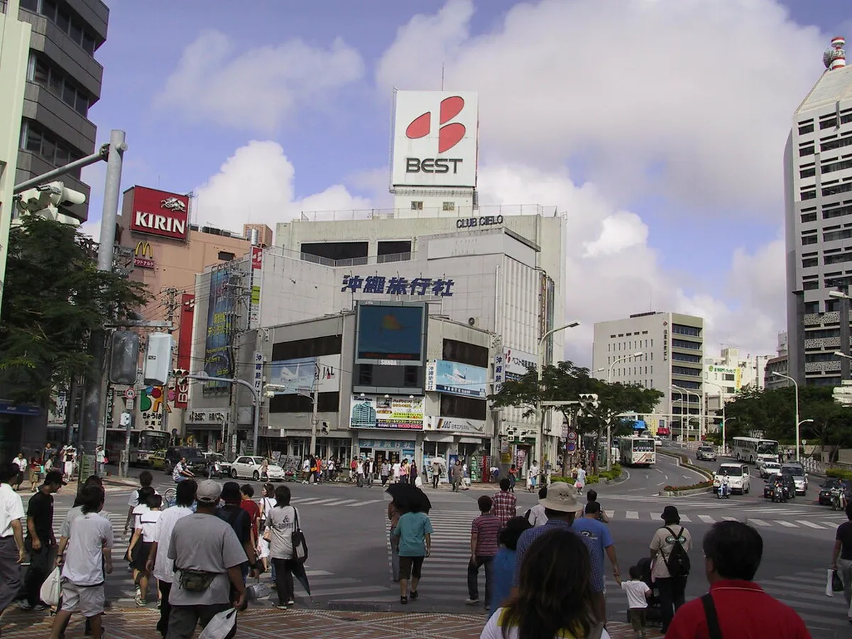 Kokusai Dori shopping street lined with colorful storefronts and signs in Naha, Okinawa, Japan