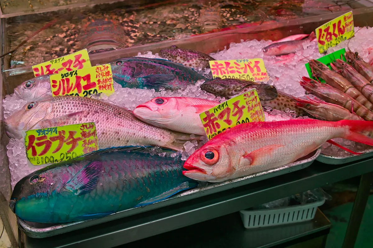 Covered market arcade near Makishi in Naha, Okinawa, with local vendors selling fresh produce and seafood