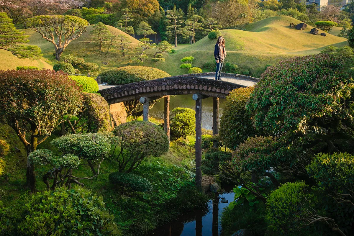 Suizenji Jojuen stroll garden with a miniature Mt. Fuji hill reflected in the pond in Kumamoto, Japan