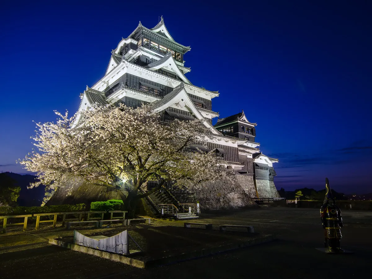 Kumamoto Castle keep and stone walls surrounded by parkland in Kumamoto, Japan