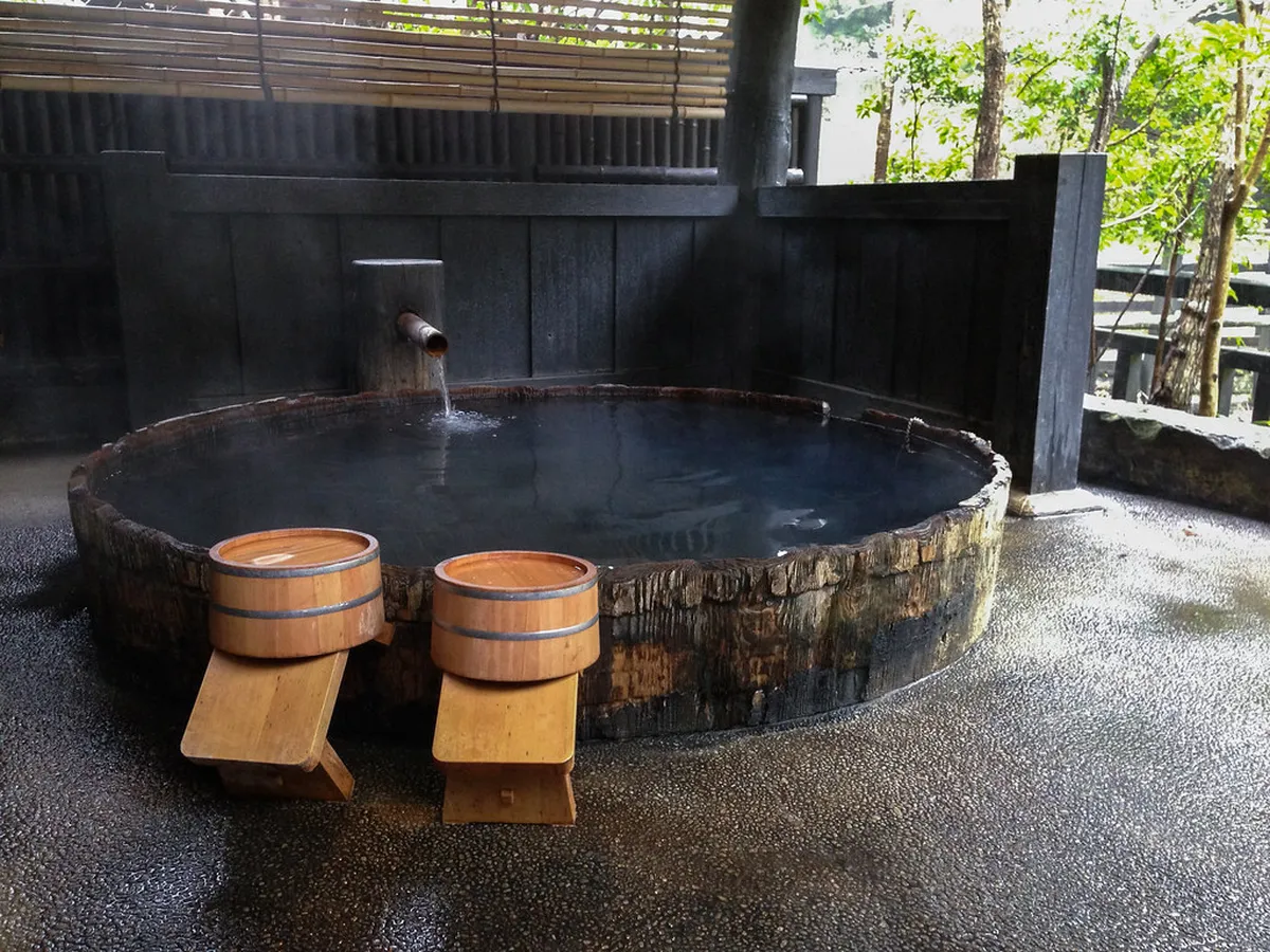 Kurokawa Onsen ryokan outdoor rotenburo bath set in a forested gorge in Kumamoto, Japan