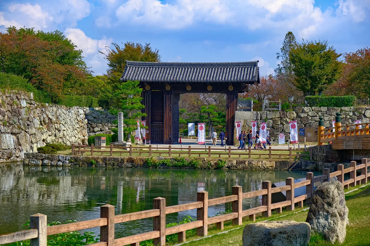 Kumamoto Castle main keep and stone ramparts viewed from the castle park in Kumamoto, Japan