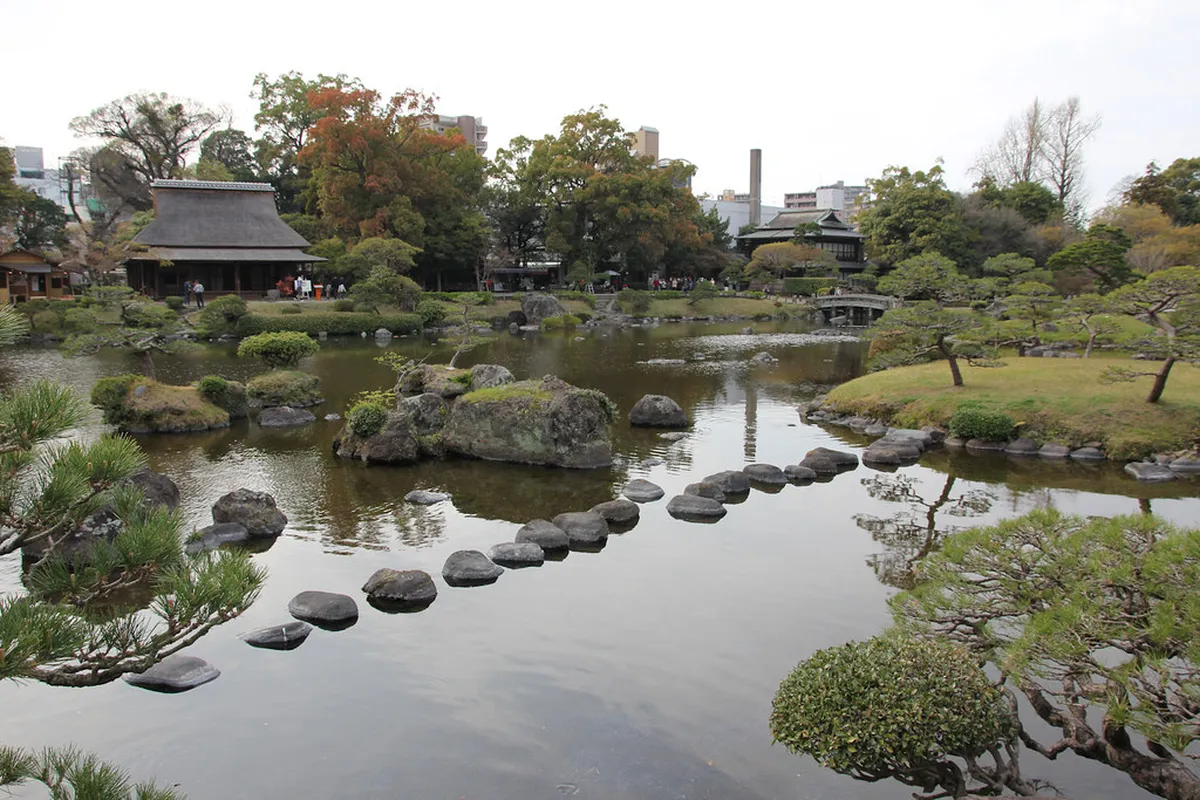 Suizenji Jojuen garden with manicured lawns and rolling hills on a clear day in Kumamoto, Japan