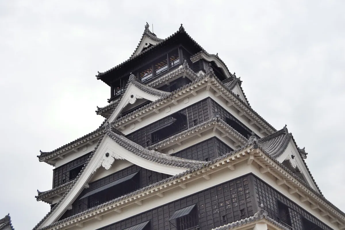 Kumamoto Castle main keep tower rising above the castle grounds in Kumamoto, Japan