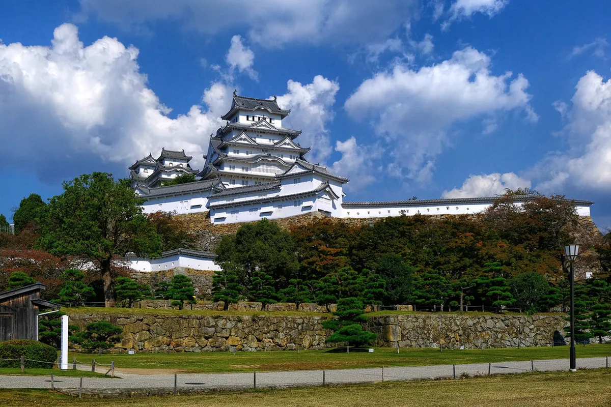 Kumamoto Castle main keep and restored stone ramparts on a bright morning in Kumamoto, Japan