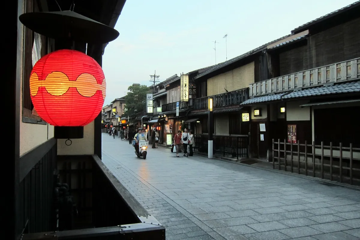 Historic Hanamikoji Street in Kyoto's Gion geisha district lined with traditional wooden teahouses at twilight, Japan