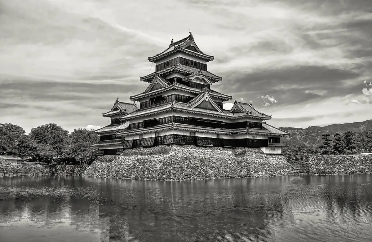 Matsumoto Castle's black-and-white keep reflected in the surrounding moat