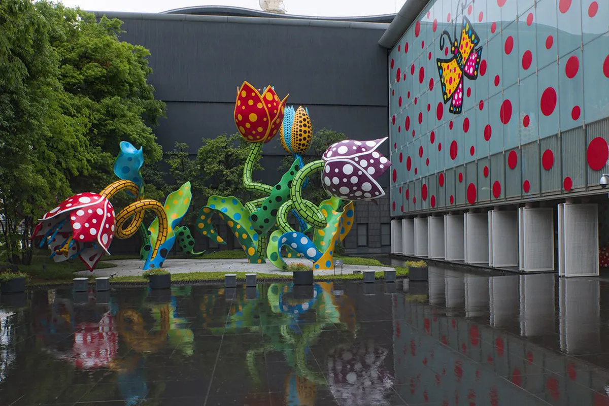 Matsumoto City Museum of Art exterior featuring Yayoi Kusama polka-dot sculpture installations in Nagano Japan