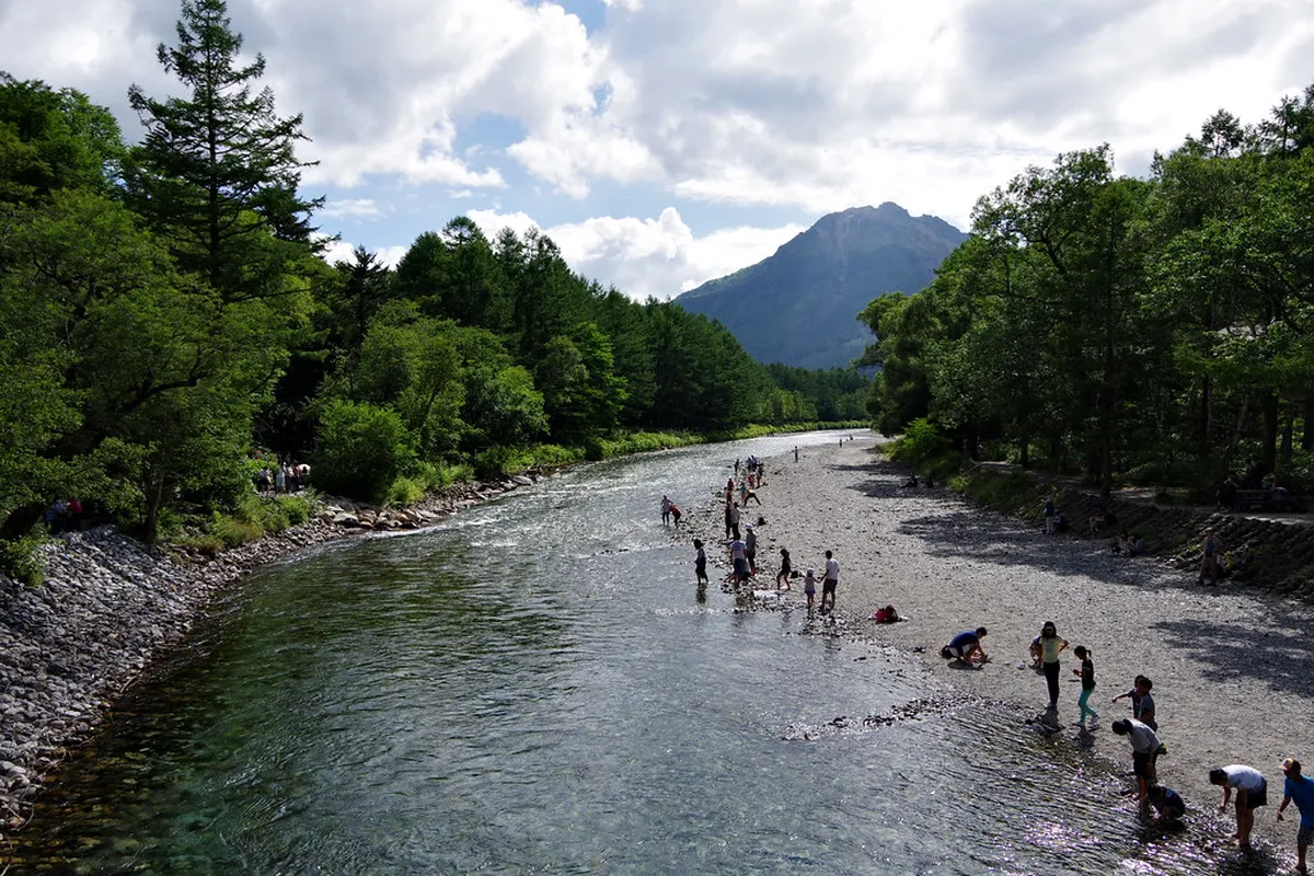 Kappa Bridge suspension bridge spanning the clear Azusa River in Kamikochi with the Hotaka Mountains, Matsumoto day trip highlight
