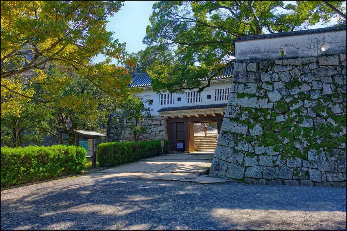 Matsumoto Castle black keep and moat with lush green trees, an iconic family attraction in Nagano, Japan
