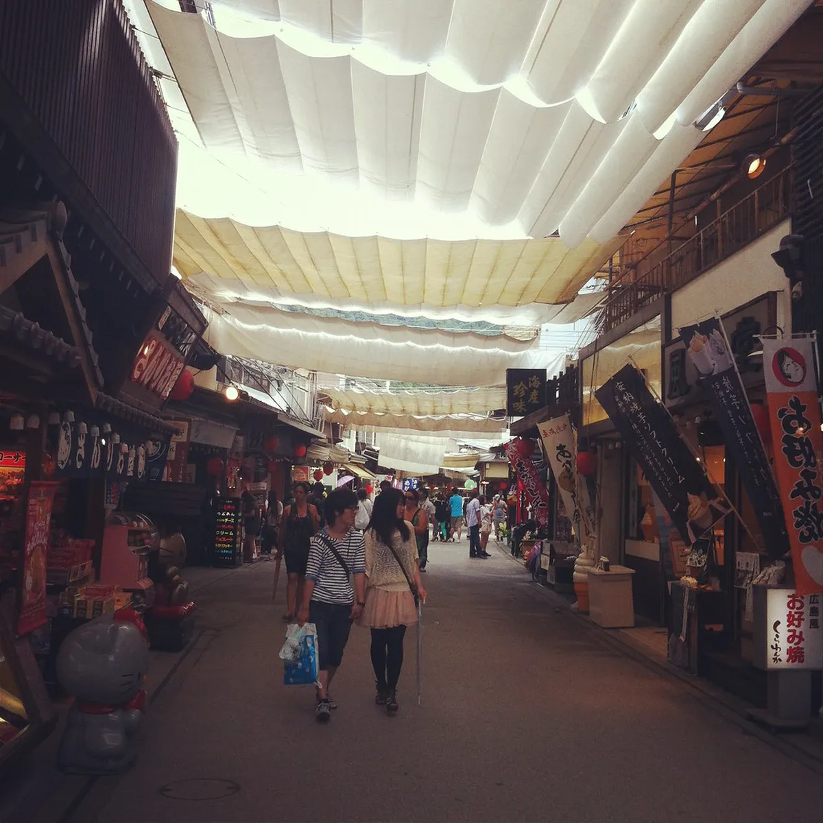 Omotesando shopping street on Miyajima Island lined with souvenir shops and momiji manju bakeries in Hiroshima, Japan