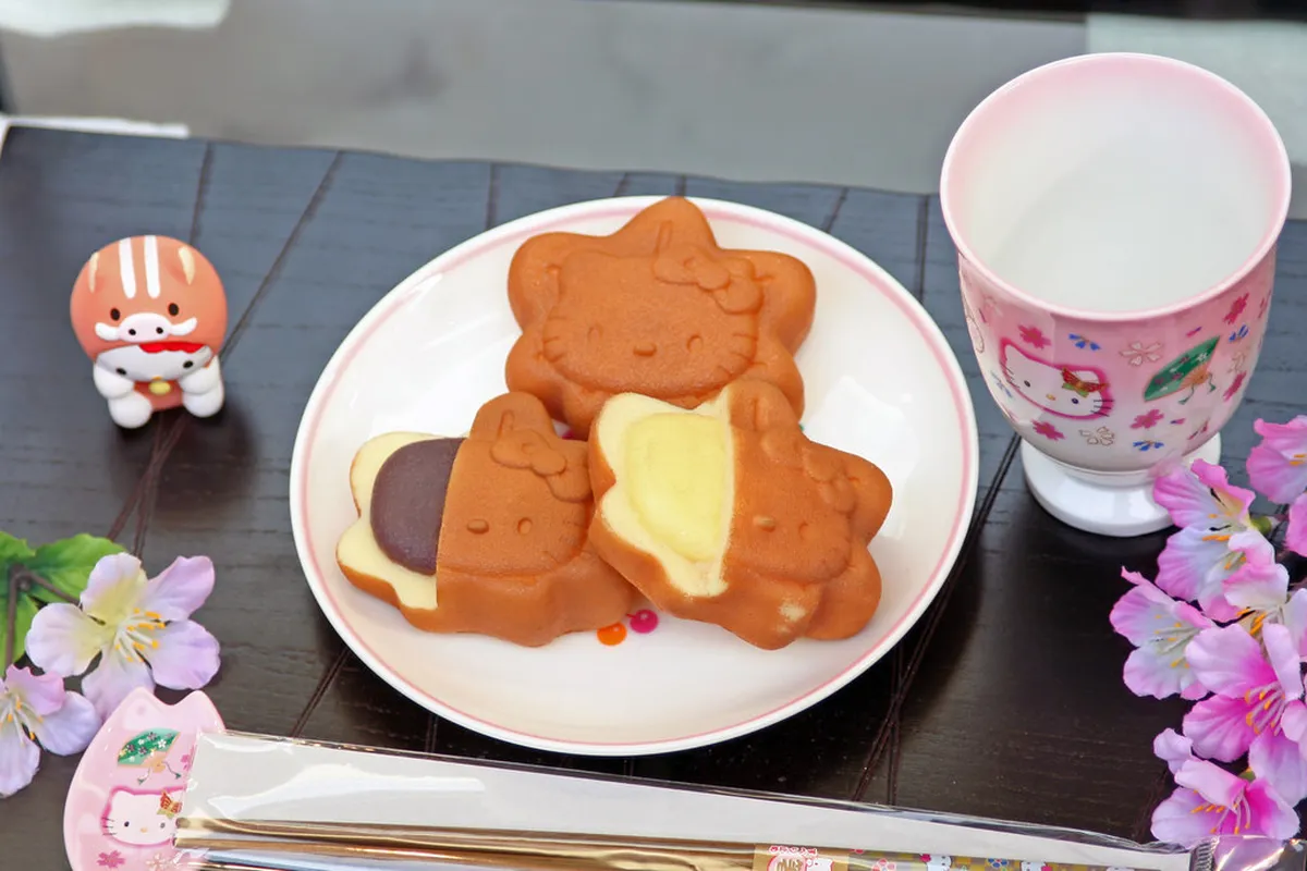 Freshly baked momiji manju maple-leaf cakes on display at a Miyajima bakery stall, Japan