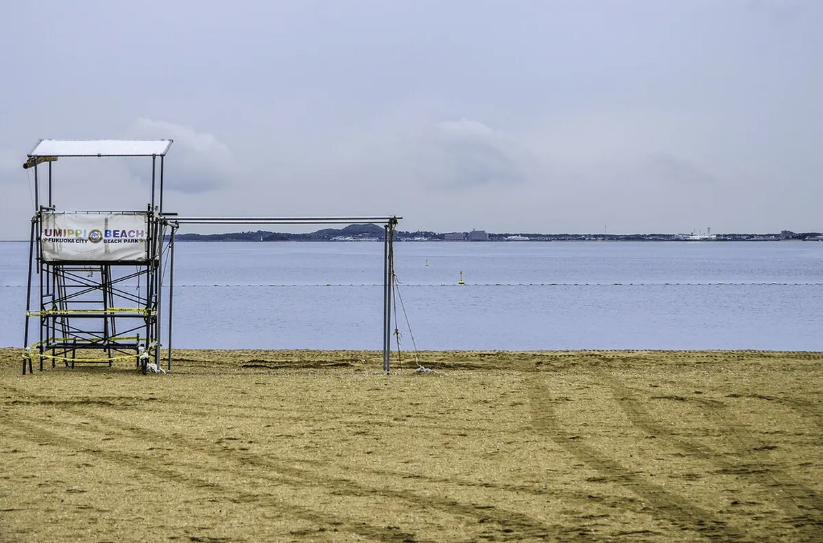 Momochihama beach on Fukuoka Bay with city skyline and calm water on a clear day, Japan