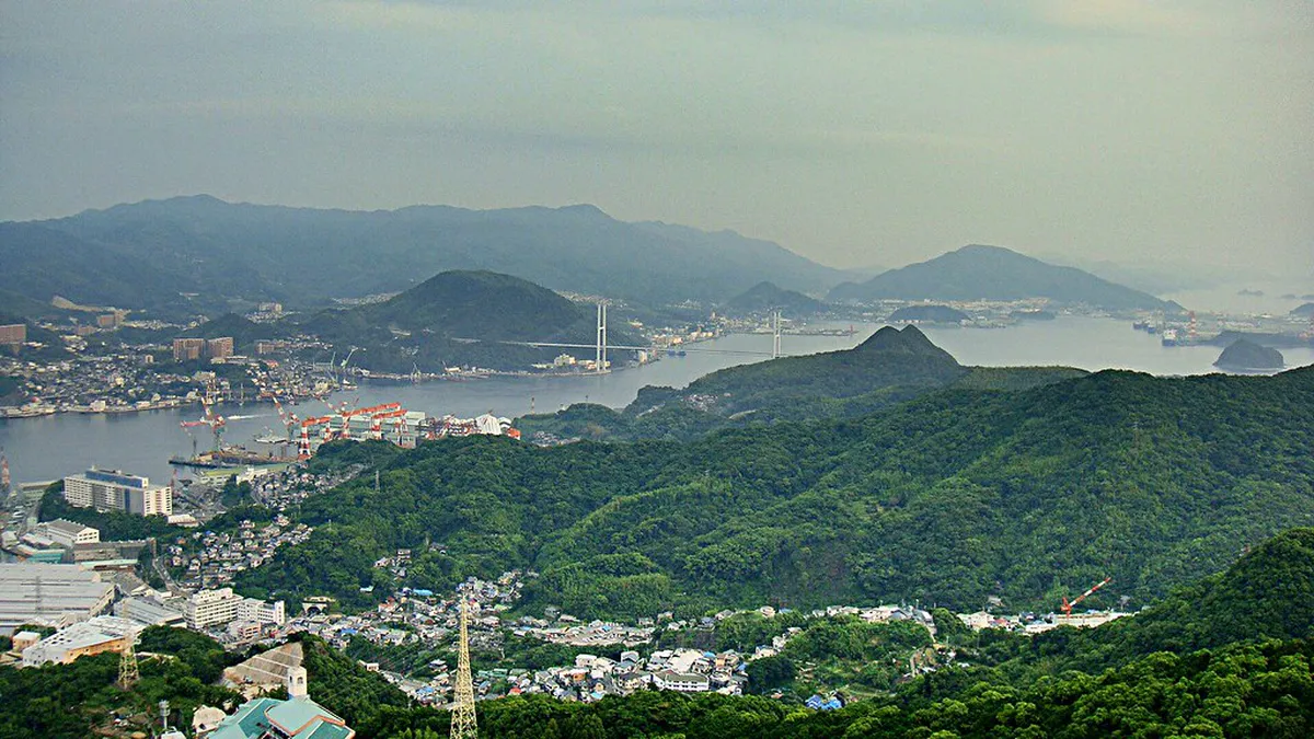 Long-exposure night photograph of Nagasaki city lights reflected in the harbour taken from Mount Inasa ropeway, Japan