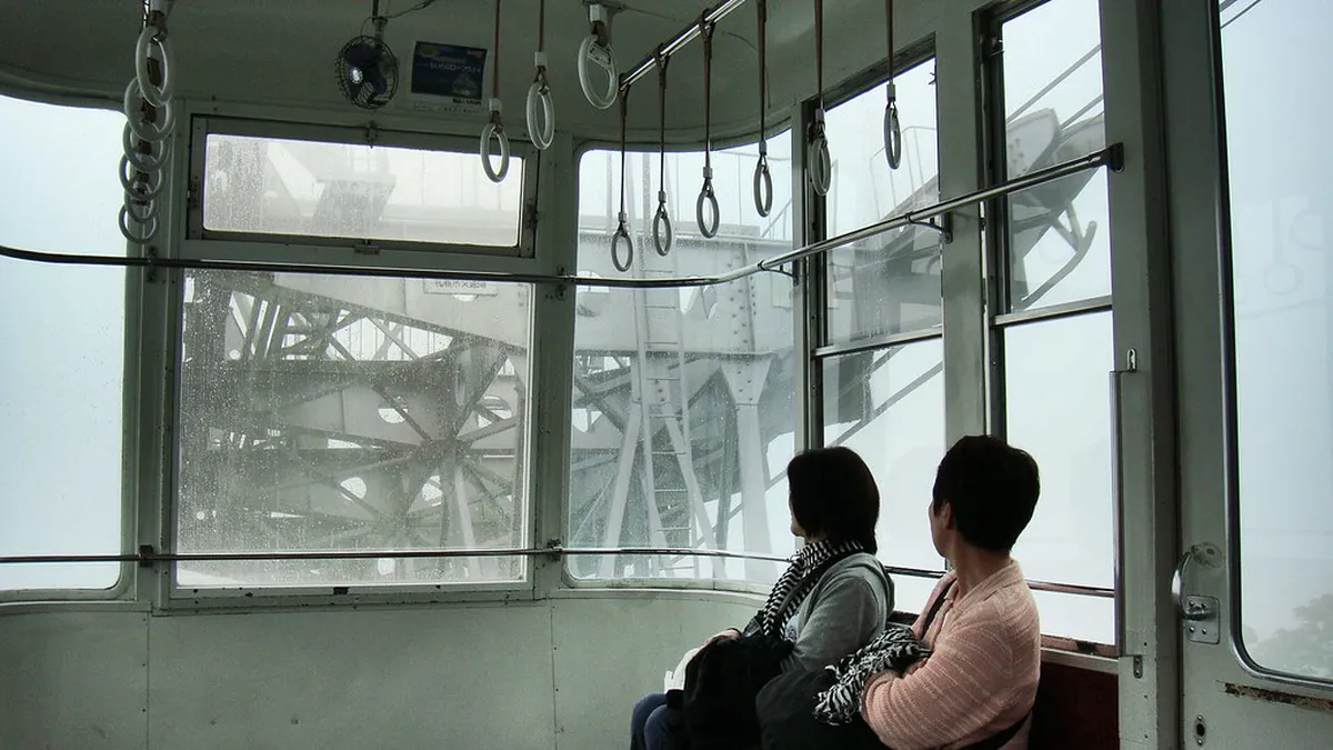 Mount Moiwa ropeway cable car ascending above the forested slopes overlooking Sapporo city in Hokkaido Japan