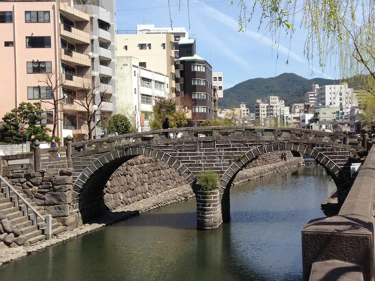 Megane Bridge stone arches reflected in Nagasaki's Nakashima River at sunrise