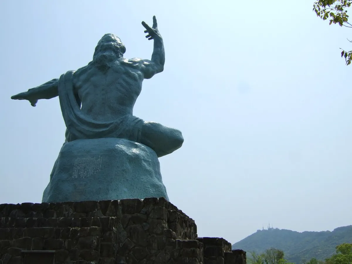 The 10-metre Peace Statue in Nagasaki Peace Park with its right hand raised toward the sky and left arm extended for peace, Japan