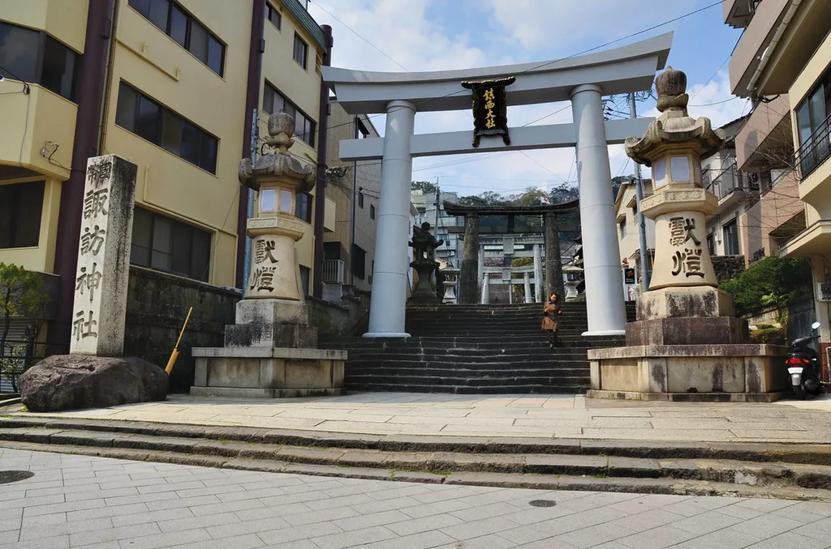 Suwa Shrine vermilion torii gate entrance at the base of the 277 stone steps in Nagasaki, Japan