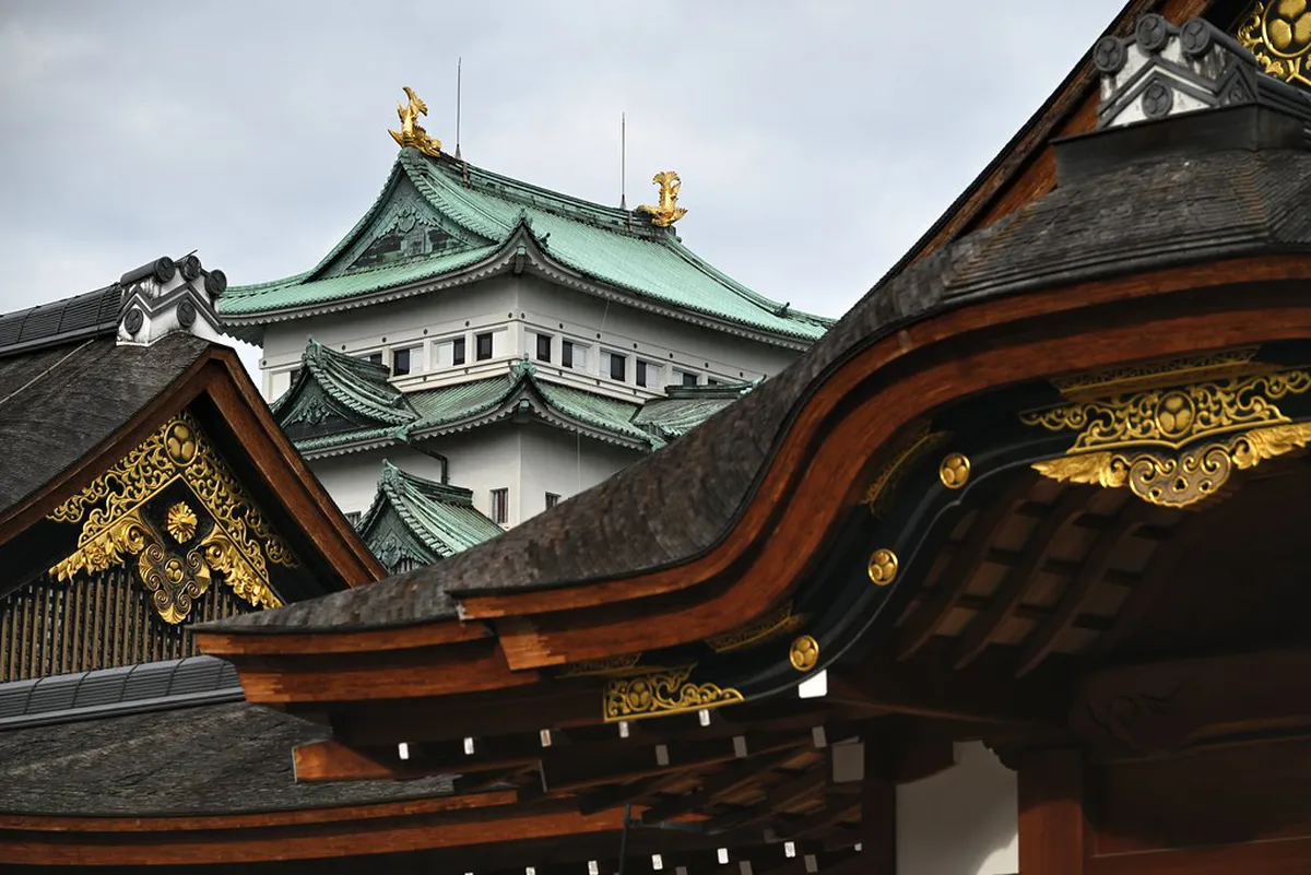 Nagoya Castle's stone walls and white tower rising above the moat, a landmark of Tokugawa-era samurai heritage in Japan