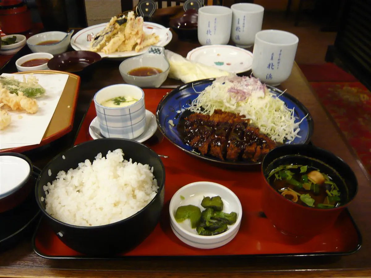 A plate of Nagoya miso katsu — a crispy pork cutlet coated in dark red-miso sauce, one of the city's most beloved local dishes
