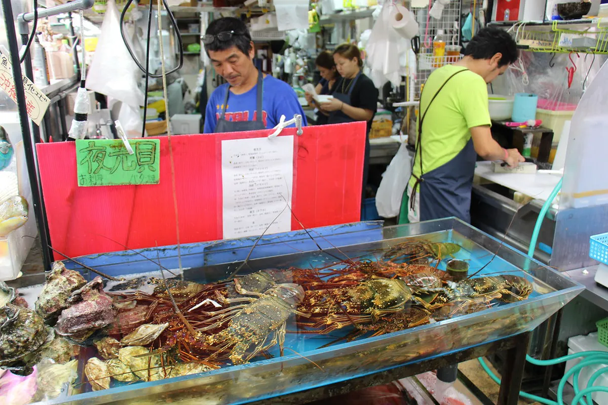 Colourful fresh produce and seafood stalls at a Naha market in Okinawa Japan