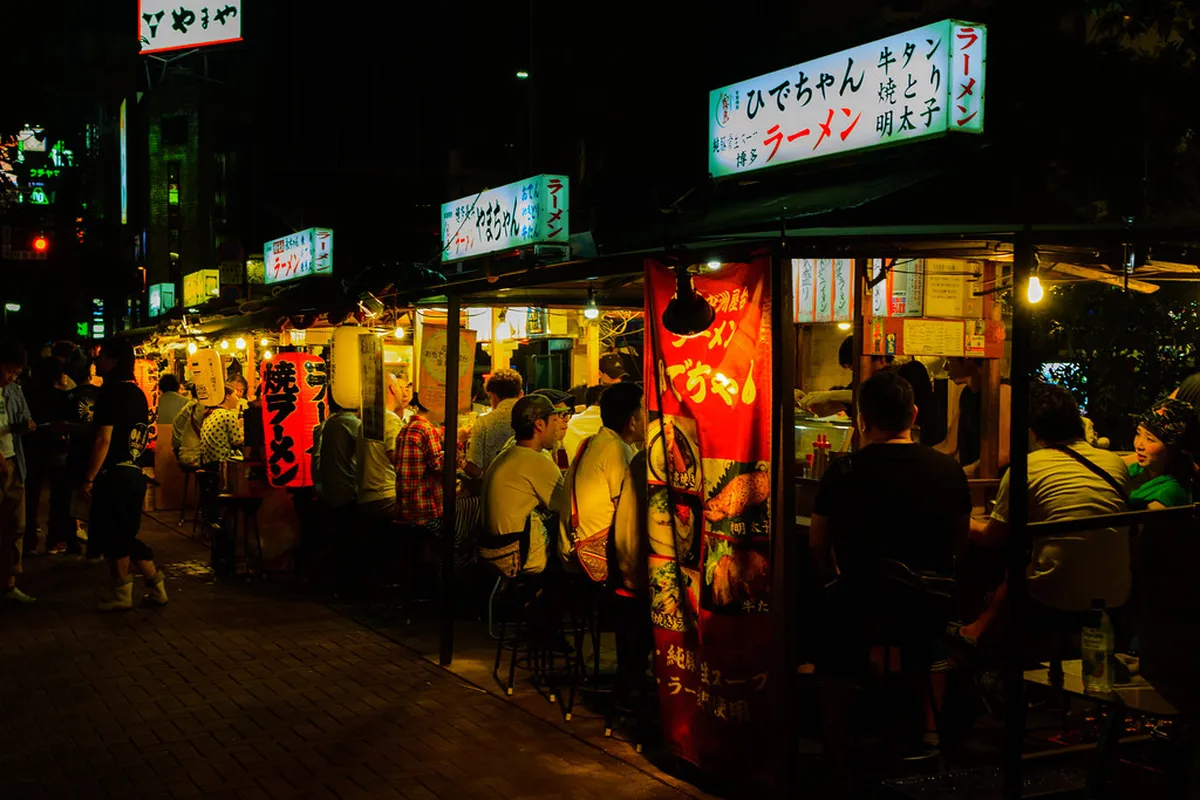 Nakasu Yatai outdoor food stalls lit up along the Nakagawa River in Fukuoka, Japan
