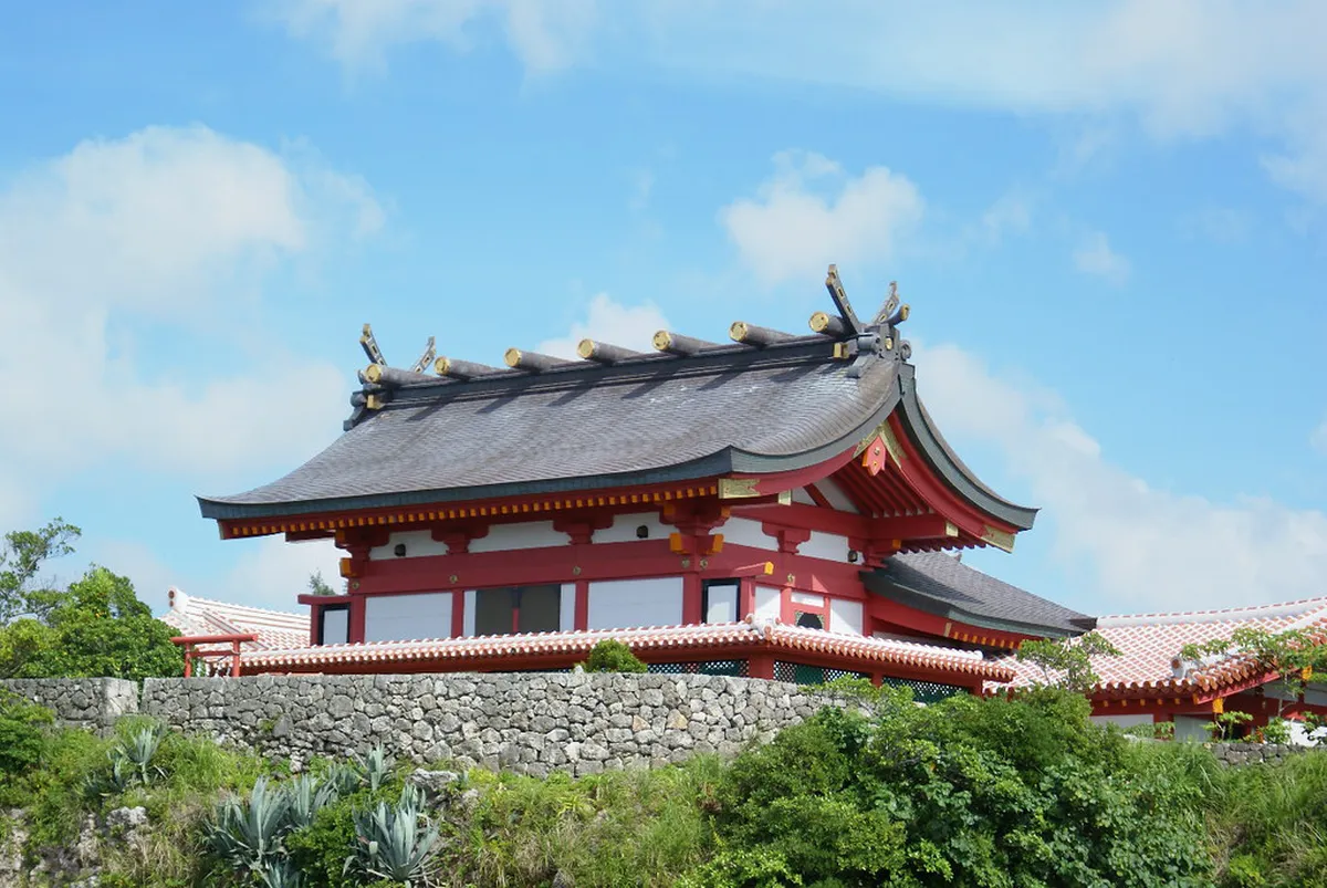 Naminoue Shrine vermilion hall perched on the coral cliff above the sea as seen from Naminoue Bridge in Naha, Okinawa
