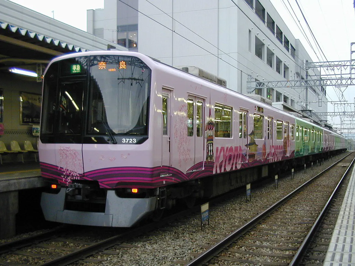 A Kintetsu express train at a station platform on the route from Osaka to Nara Japan
