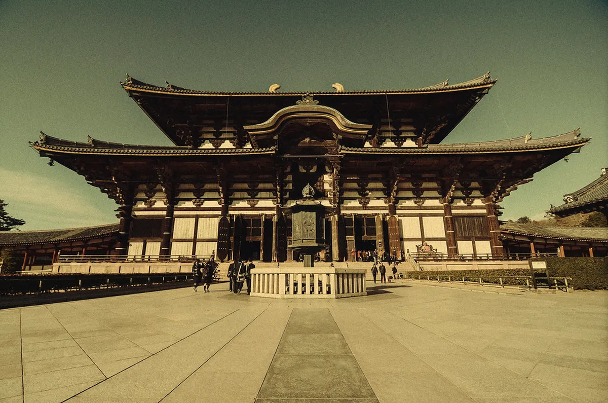 The towering Nandaimon Great South Gate of Todai-ji Temple with visitors at the entrance in Nara Japan