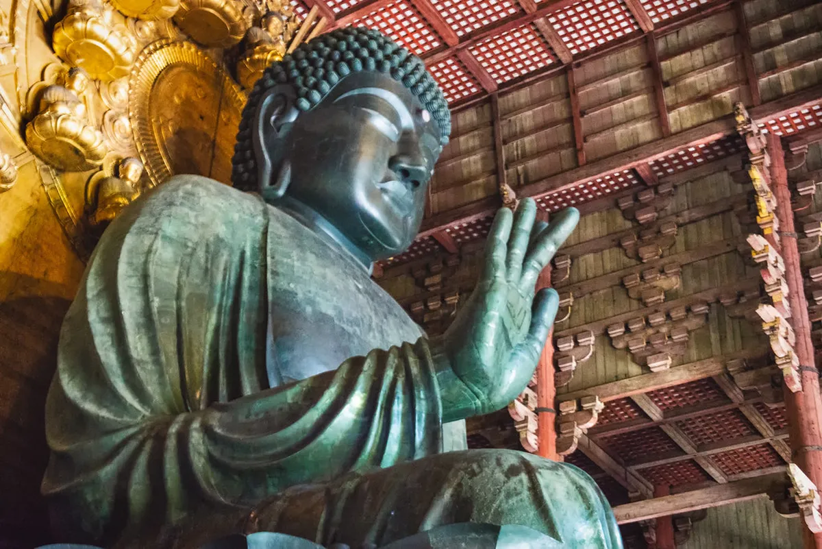 The colossal bronze Great Buddha inside Todaiji temple in Nara, towering 15 meters beneath the great wooden hall