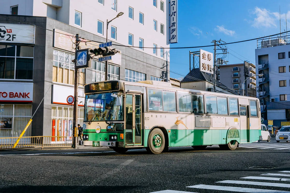 A Nara Kotsu city bus at a stop near Nara Park, serving as the main public transit connection between sightseeing areas in Nara, Japan