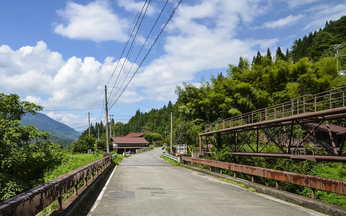 Hikers walking the historic Nakasendo trail through cedar forest in Nagano Prefecture, following the ancient route between Edo-period post towns in Japan