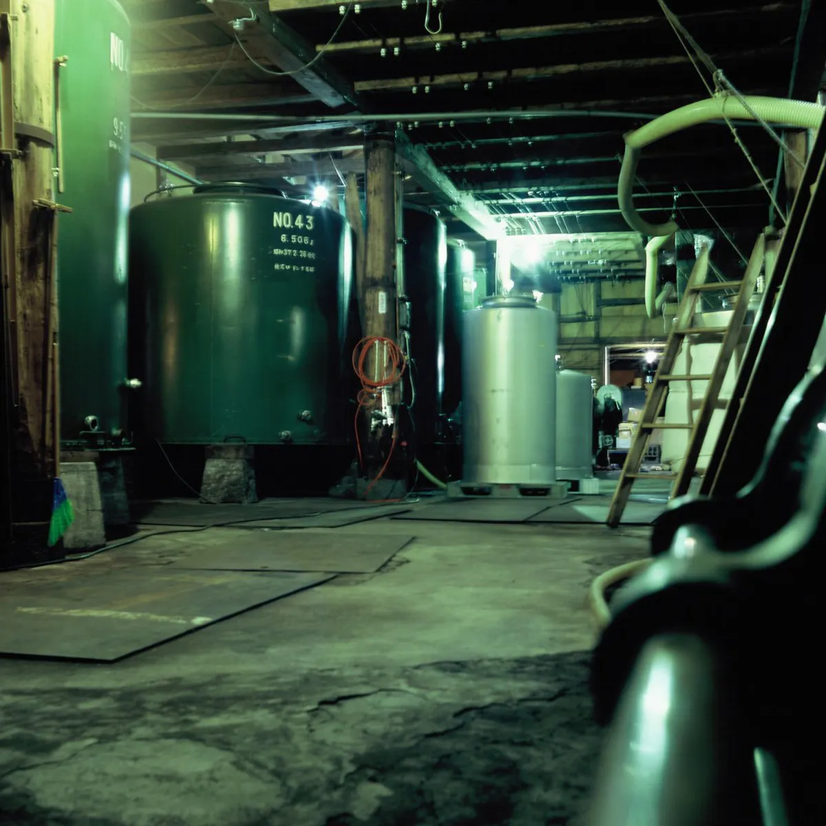 Traditional sake brewery vessels in a Japanese artisan brewery using pure mountain water