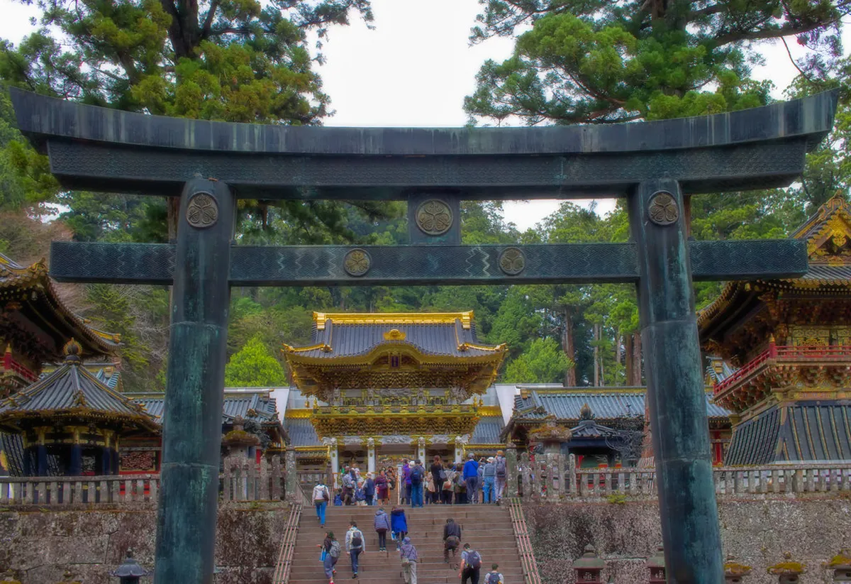 Cedar-lined path leading up to the ornate gates of Nikko's UNESCO shrine complex in Japan