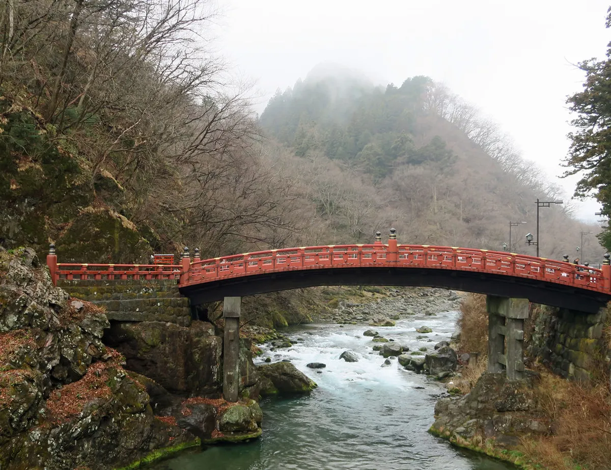 Bright vermilion Shinkyo Bridge spanning the Daiya River at the entrance to Nikko's sacred grounds, Japan