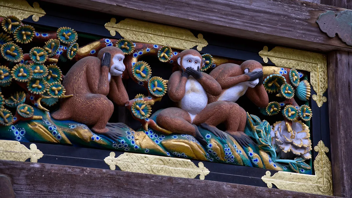 The famous Three Wise Monkeys wood carving on the Sacred Stable at Toshogu Shrine in Nikko, Japan