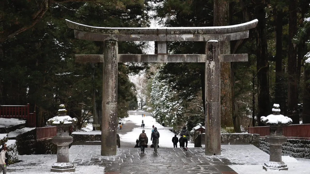 Intricate gold leaf and vermilion lacquer carvings on the Toshogu Shrine gate in Nikko, Japan