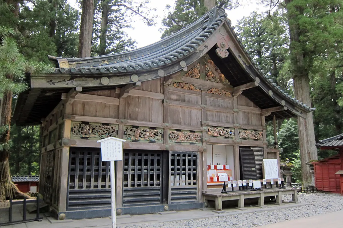Cedar-lined stone pathway leading to the historic shrine complex in Nikko, Japan