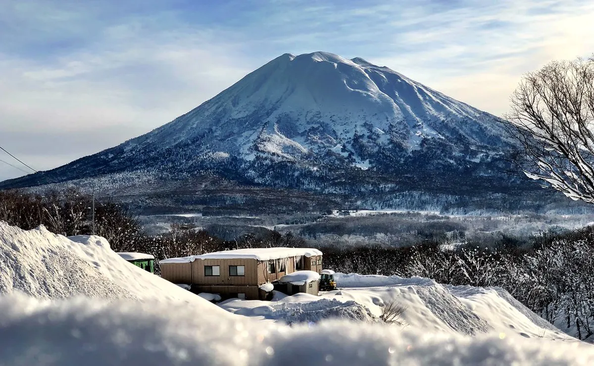Snow-covered lodge and deep powder snowfields at Niseko resort in Hokkaido, Japan during winter