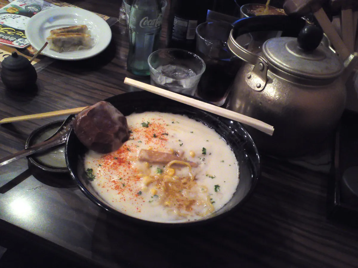 Steaming bowl of Niseko-style ramen with rich broth and toppings served at a restaurant in Japan