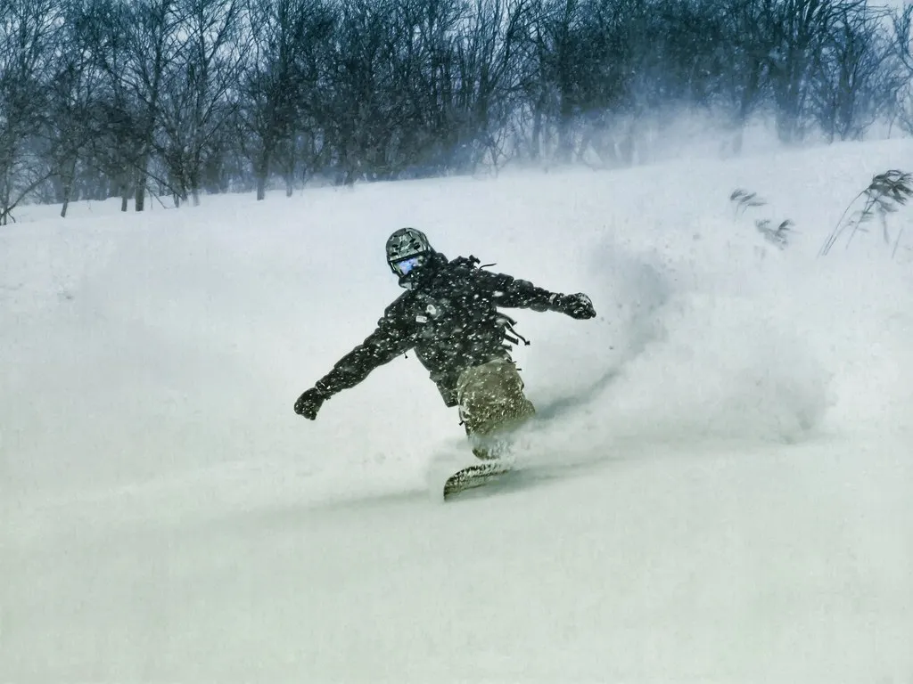 Snowboarder freeriding in Niseko powder during peak season