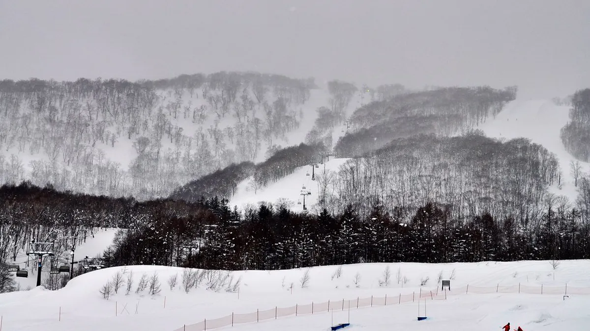 Niseko Village powder skiing with deep Hokkaido snow on the mountain slopes, Japan